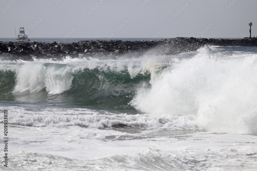 Large powerful wave crash at The Wedge in Newport Beach during a south swell 