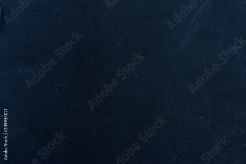Black wooden board as a background. Empty place for an inscription.