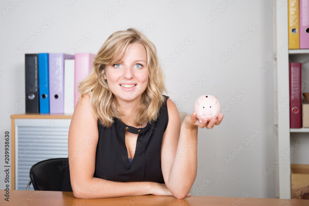 Business woman is holding piggy bank Financial budget saving concept on the office desk Business woman is holding piggy bank Financial budget saving concept on the office desk