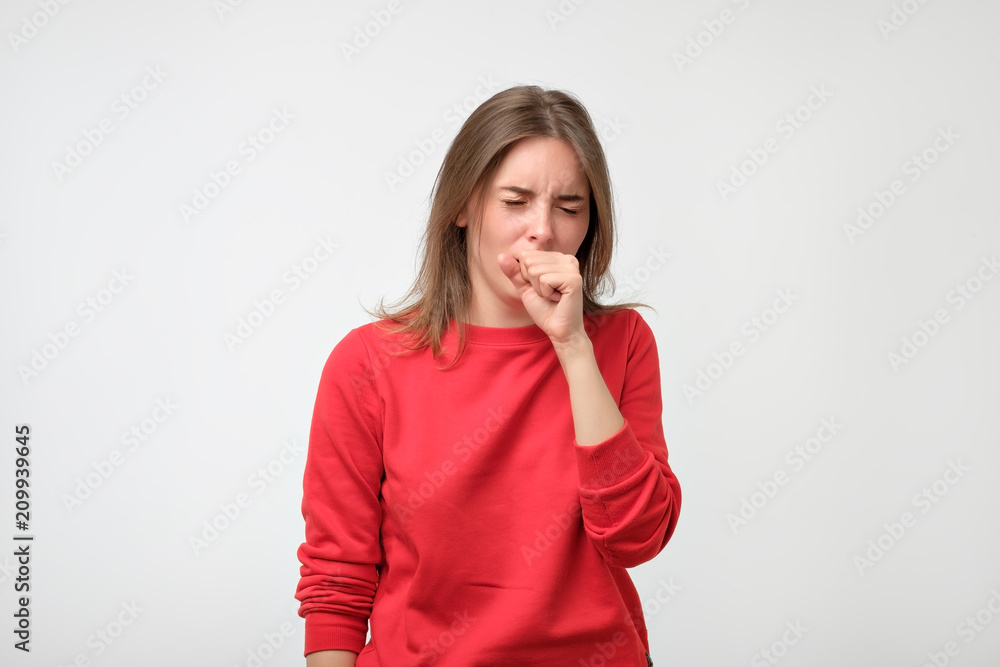unhappy caucasian woman in red pulover suffering from throat pain at home unhappy caucasian woman in red pulover suffering from throat pain at home