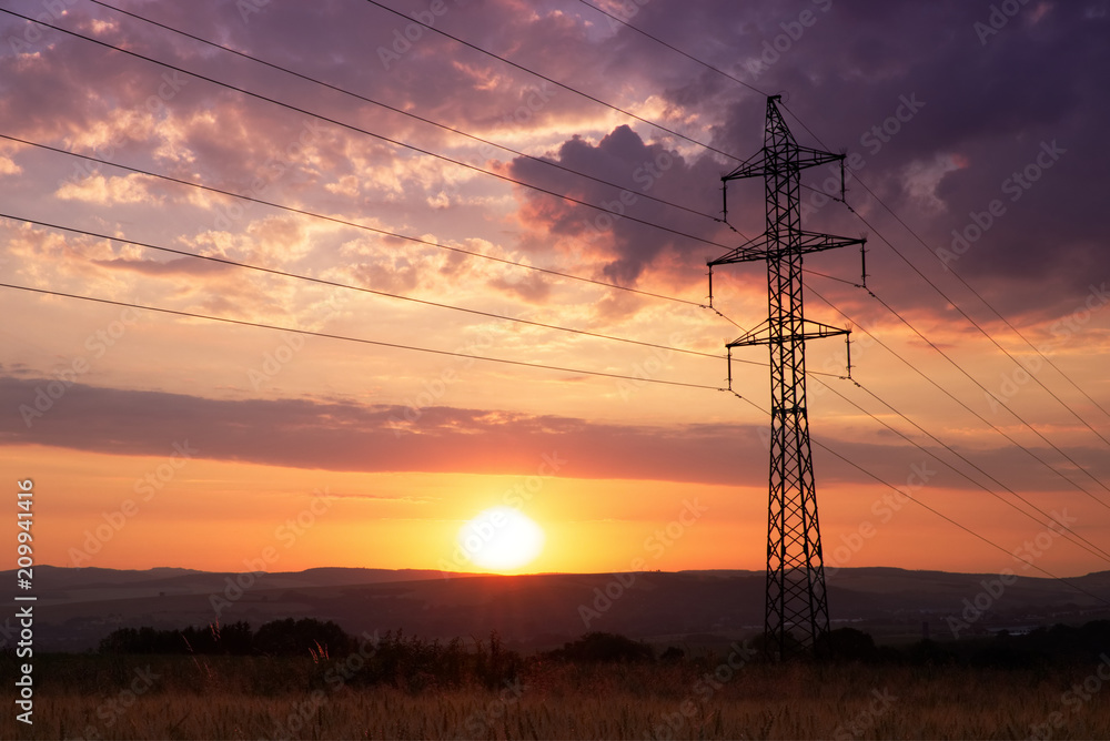 Sunset behind electricity pylon