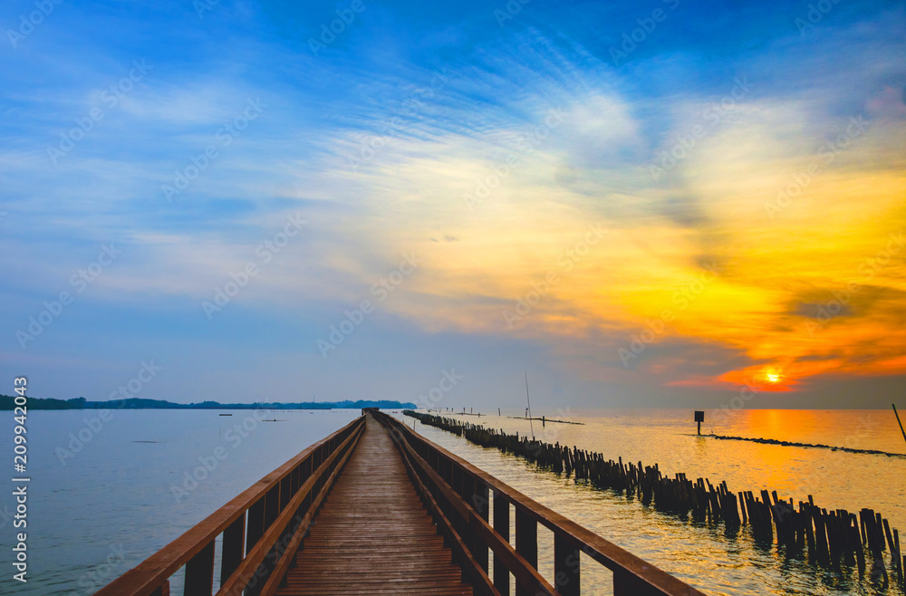 In the morning The red bridge and sun up on horizon.  bridge cross sea in Thailand .Thailand landscape .