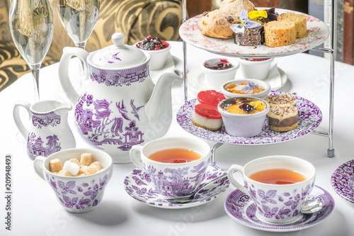 Obraz na płótnie old school style tea at five afternoon service sandwich set cake sweet traditional table hotel cheesecake sugar pot china cup w salonie