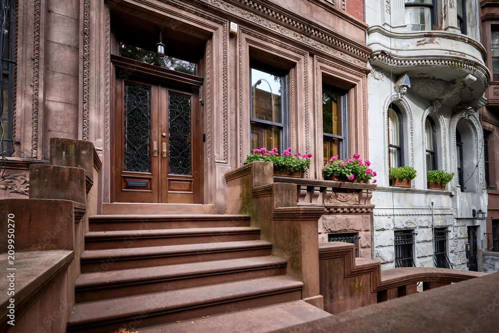 a row of brownstone buildings and stoops in an iconic neighborhood of Manhattan, New York City a row of brownstone buildings and stoops in an iconic neighborhood of Manhattan, New York City