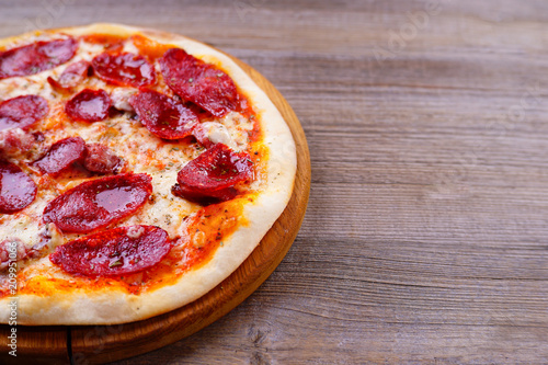 Classical italian pepperoni pizza on wood, copy space. Food delivery, restaurant menu, pizzeria