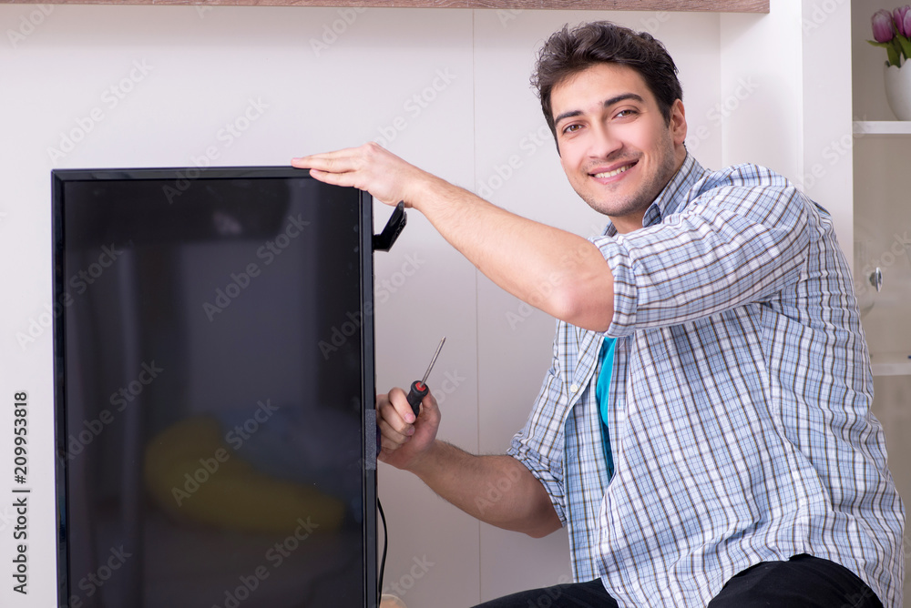 Man repairing broken tv at home Man repairing broken tv at home