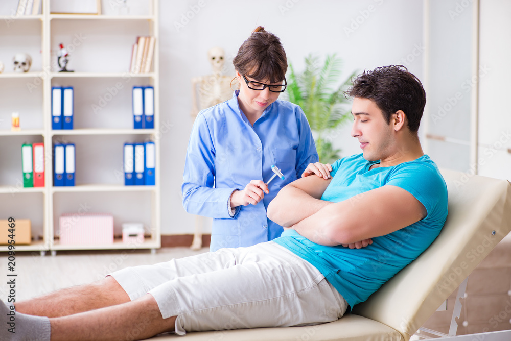 Doctor checking nerve reflexes with hammer