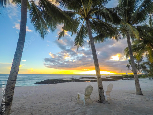 Two deck chairs under palm trees at sunset on an empty beach at Lefaga, Matautu, Upolu Island, Samoa, South Pacific photo