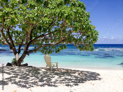 Solitude - a single deckchair for relaxation in the shade on a beautiful tropical sandy beach at Lefaga, Matautu, Upolu Island, Samoa, South Pacific photo