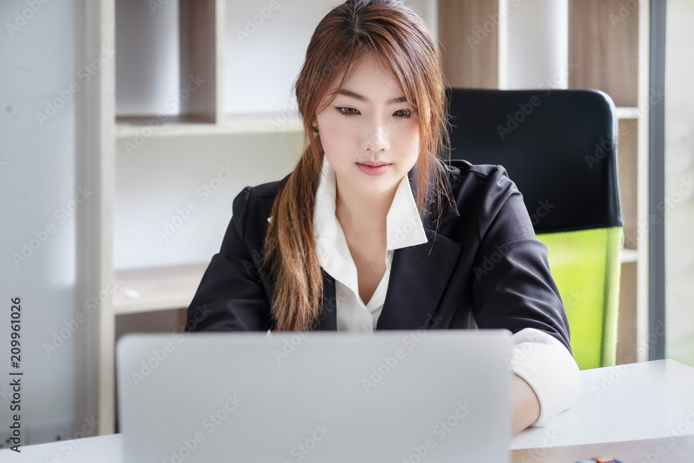 Asia business accounting concept, woman using laptop computer in office. Asia business accounting concept, woman using laptop computer in office.