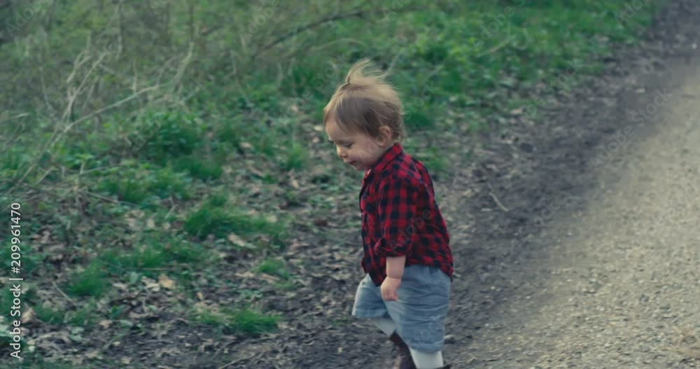 Little toddler playing with a stick in the forest Little toddler playing with a stick in the forest