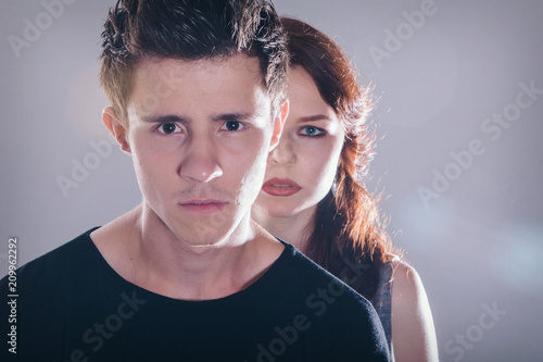 Cropped image of a beautiful couple looking at the camera standing right