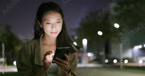 Photography Woman working on smart phone at night
