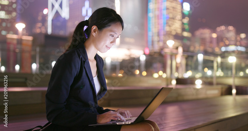 Photography Business woman work on laptop computer at night