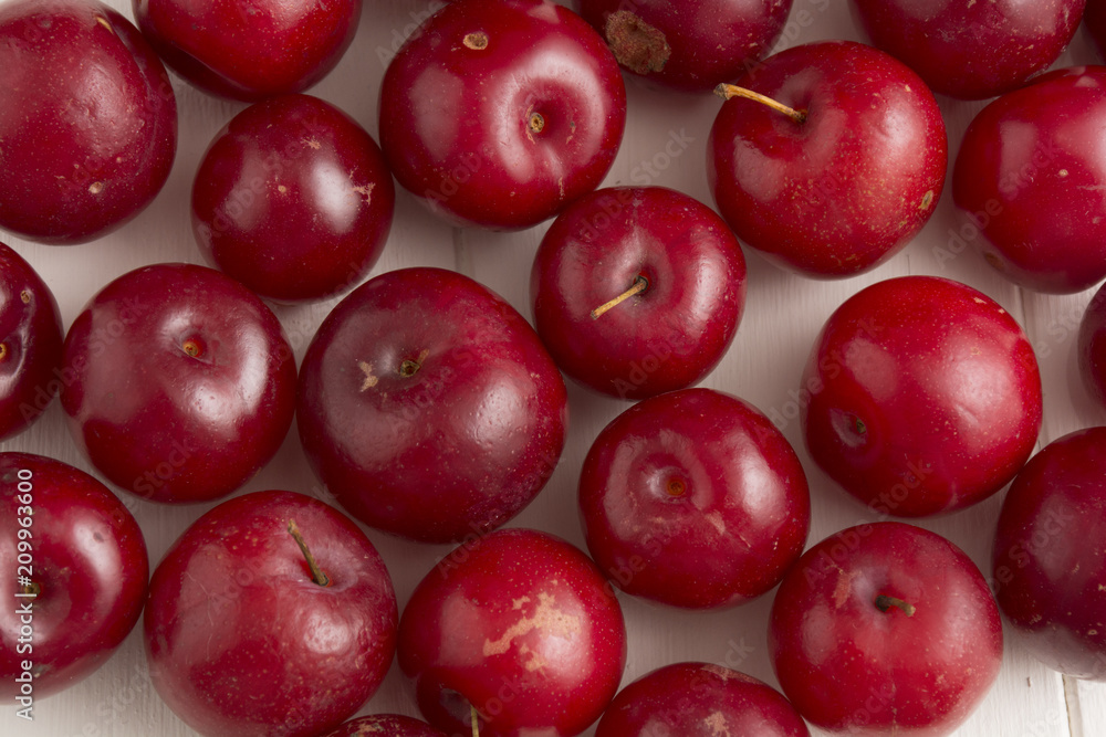 Fresh red plums, on white background.
Fresh red plums, on white background.