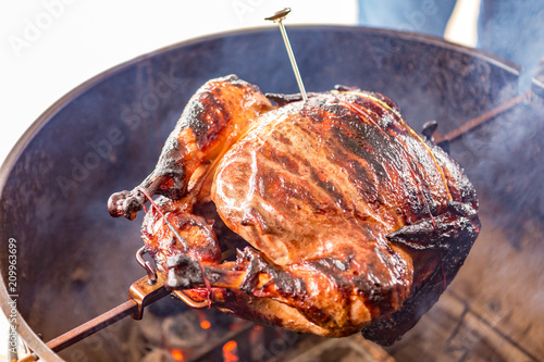 Turkey with thermometer on the barbecue grill