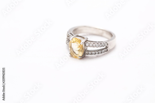 Yellow gem stone on diamond ring