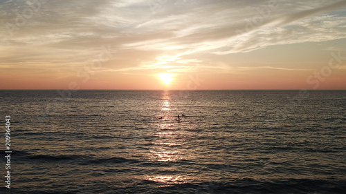 Fototapeta Naklejka Na Ścianę i Meble -  SUP surfing paddleboard at sunset