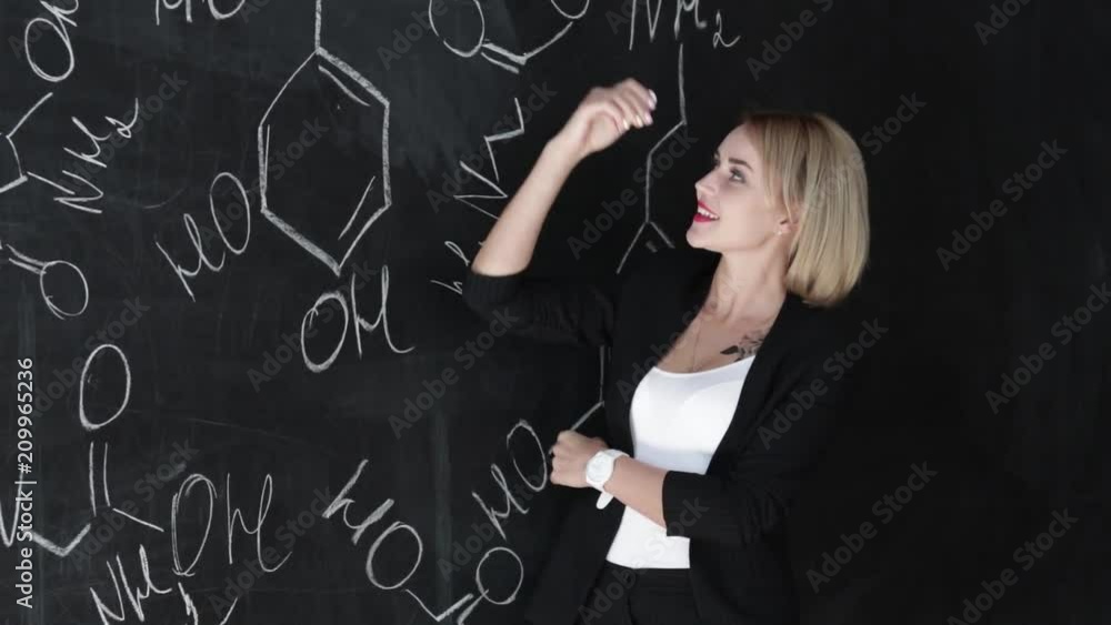 Learn science or chemistry formula confident beautiful woman teacher chalk blackboard background Learn science or chemistry formula confident beautiful woman teacher chalk blackboard background