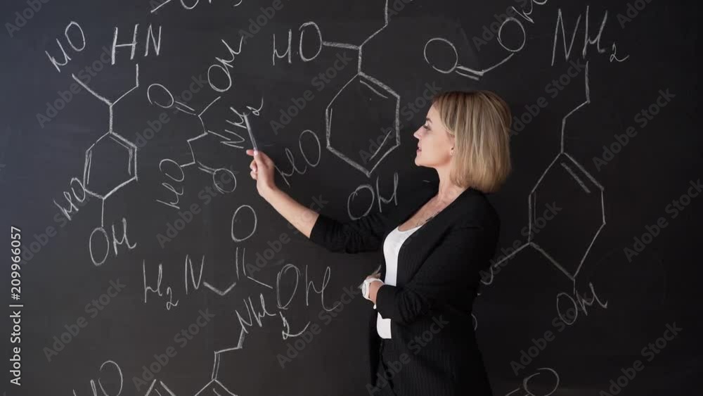 Learn science or chemistry formula confident beautiful woman teacher chalk blackboard background Learn science or chemistry formula confident beautiful woman teacher chalk blackboard background