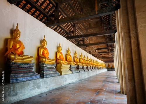 Travel Thailand - Golden buddha statue in Wat Phutthaisawan, Ayutthaya Historical Park. Space for text in template. photo