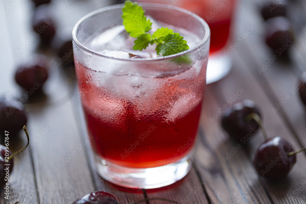 Fresh cold cherry cocktail with mint and ice. Fresh cold cherry cocktail with mint and ice.
