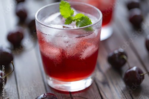 Fresh cold cherry cocktail with mint and ice.