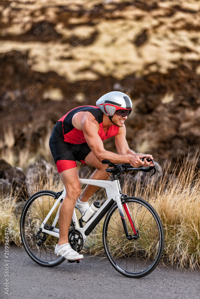 Triathlon professional cyclist man cycling road racing bike in time trial  helmet and compression tri suit in Hawaii landscape for Kailua-Kona ironman.  Triathlete biking in nature. Stock-foto | Adobe Stock