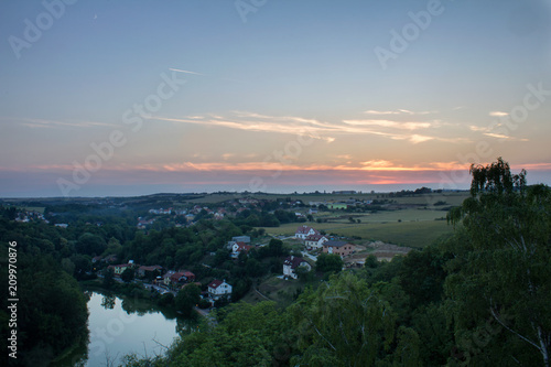 View from Ales lookout to small village Unetice in sunset, Czech landscape