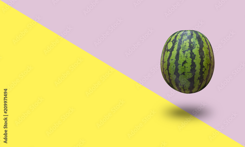 Watermelon isolated on a yellow and pink pastel background with a shadow Watermelon isolated on a yellow and pink pastel background with a shadow