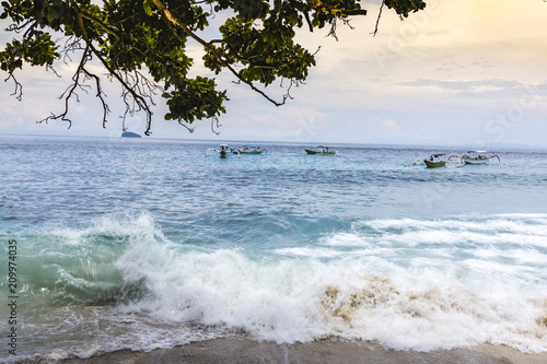 Coast the ocean with waves and small boats