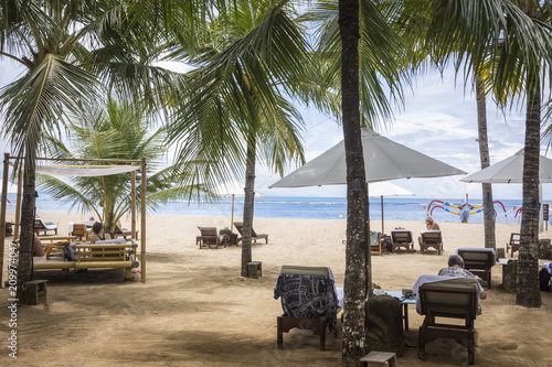 Beach with umbrella and chaise-longue