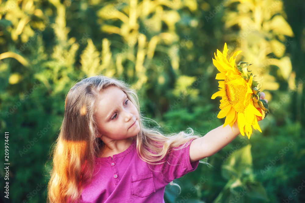Cheerful girl holding a sunflower flower Cheerful girl holding a sunflower flower