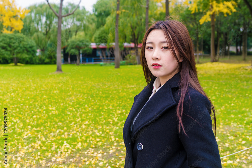 Portrait of Beautiful Chinese Woman in black with Autumn meadows Background. Portrait of Beautiful Chinese Woman in black with Autumn meadows Background.
