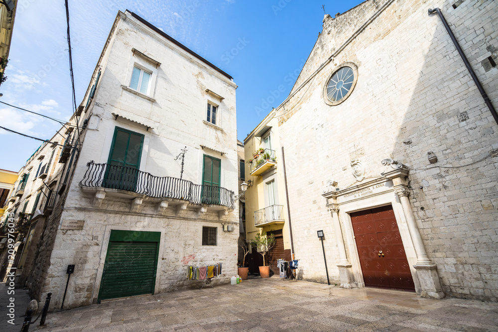 Small square with a traditional building and a small church in Bari old town (called in Italian 
