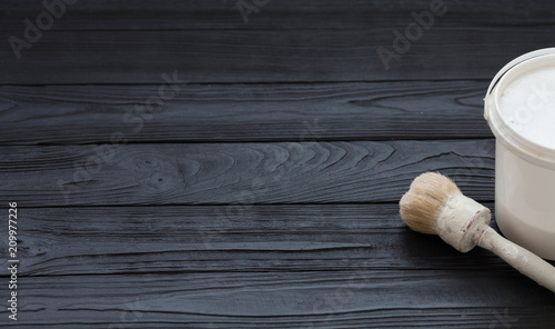 Black wooden background. Horizontal image of paintbrushes on wooden board.
