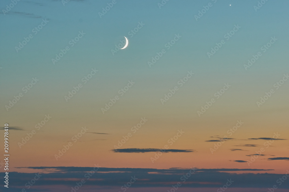 Fototapeta premium crescent in the sunset sky on the seashore