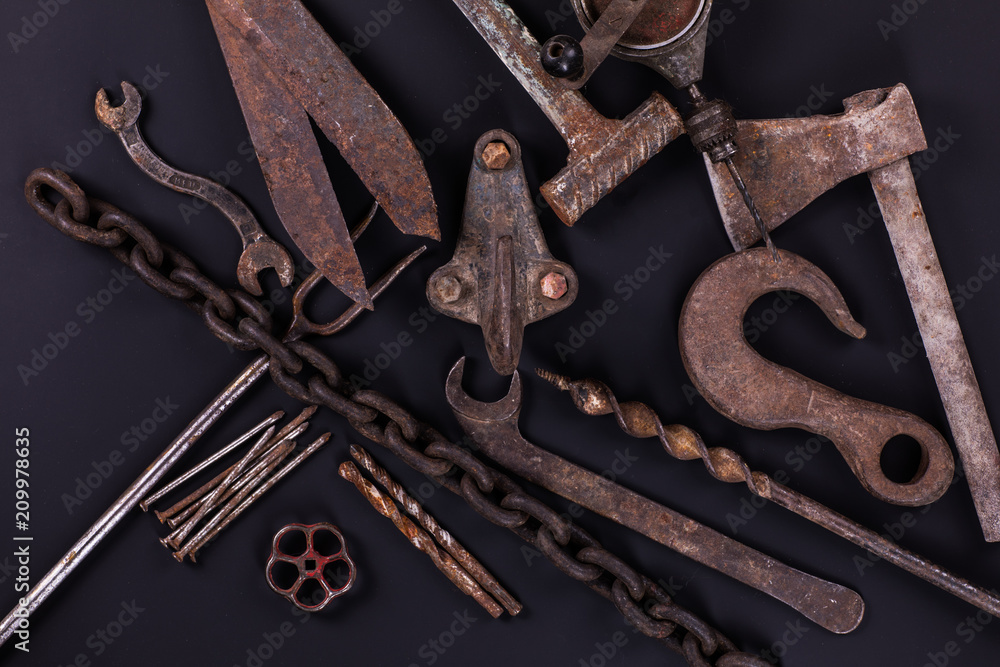 set of old rusty hand tools on a black background