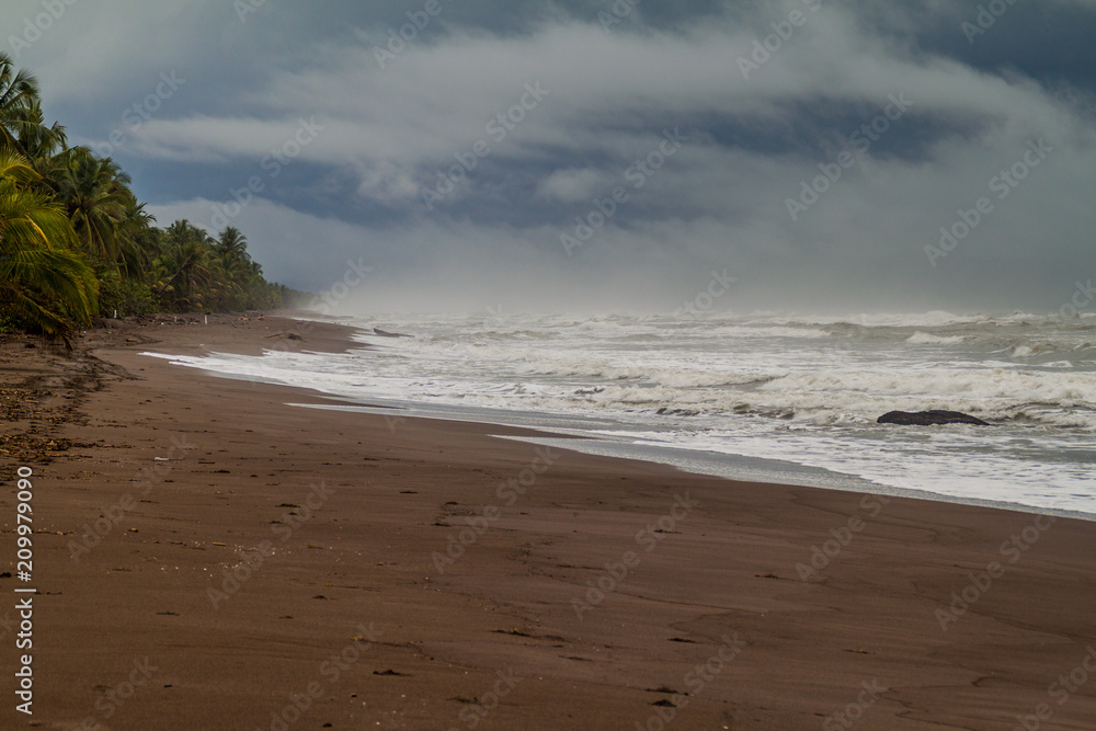 Dramatic sky and a stormy sea at a beach in Tortuguero National Park, Costa Rica