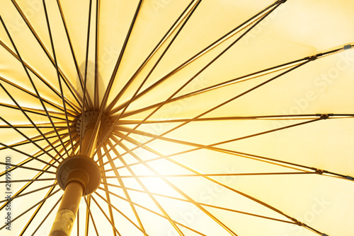 summer season coming, yellow umbrella low angle view under sunshine © PORNCHAI SODA