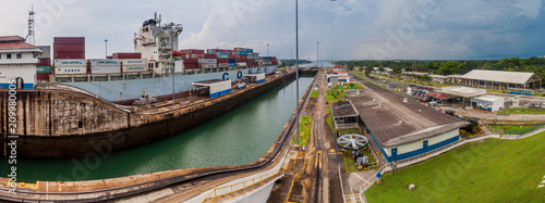GATUN, PANAMA - MAY 29, 2016: Container ship Cosco Boston is passing through Gatun Locks, part of Panama Canal. photo