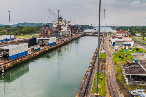 GATUN, PANAMA - MAY 29, 2016: Container ship is passing through Gatun Locks, part of Panama Canal.