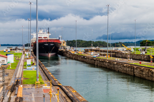 Container ship is  passing through Gatun Locks, part of Panama Canal photo