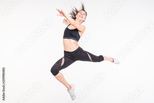  Sporting girl is engaged in fitness on a white background