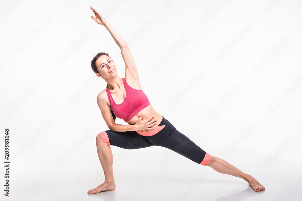 Sporting girl is engaged in fitness on a white background Sporting girl is engaged in fitness on a white background