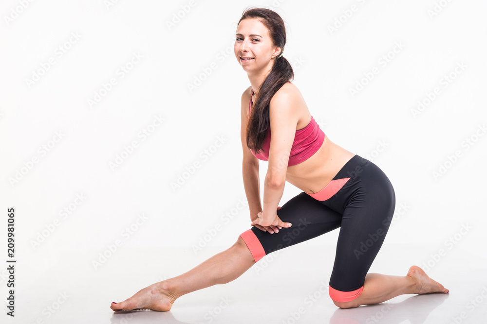 Sporting girl is engaged in fitness on a white background Sporting girl is engaged in fitness on a white background