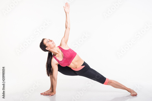  Sporting girl is engaged in fitness on a white background