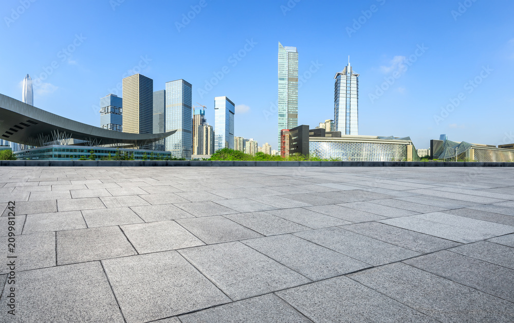 Empty square floor and modern city commercial architecture panorama in shenzhen,China