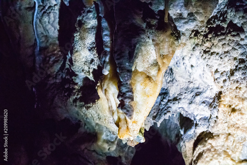 Illuminated multicolored stalactites in cave HAN-SUR-LESSE