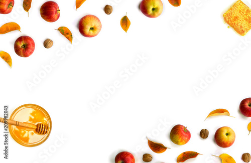 Fototapeta Naklejka Na Ścianę i Meble -  Ripe yellow red juicy apples with leaves, honey, honeycombs and walnuts autumn on white background with space for text. Top view, flat lay